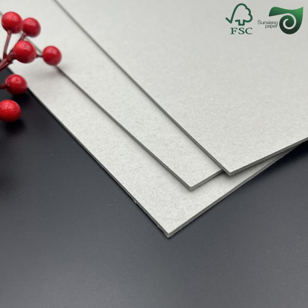 Double sided grey chipboard sample showing smooth surface and rigid structure
