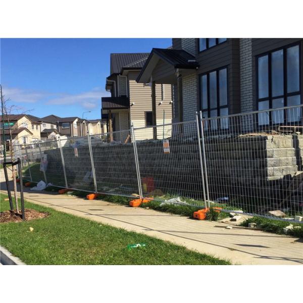 galvanized temporary fence panels with plastic feet and clamps installed on house site