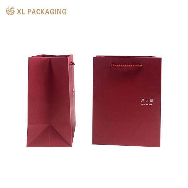 Luxury Wine Red Paper Gift Bag with Custom Logo, Reinforced Folded Bottom, and Twisted Paper Handles for Premium Shopping and Gift Packaging
