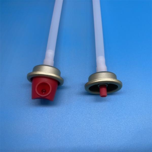 Close-up view of fire extinguisher valve red button actuator