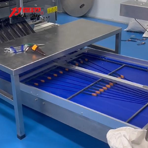 Side view of packaging machine showing material feed system