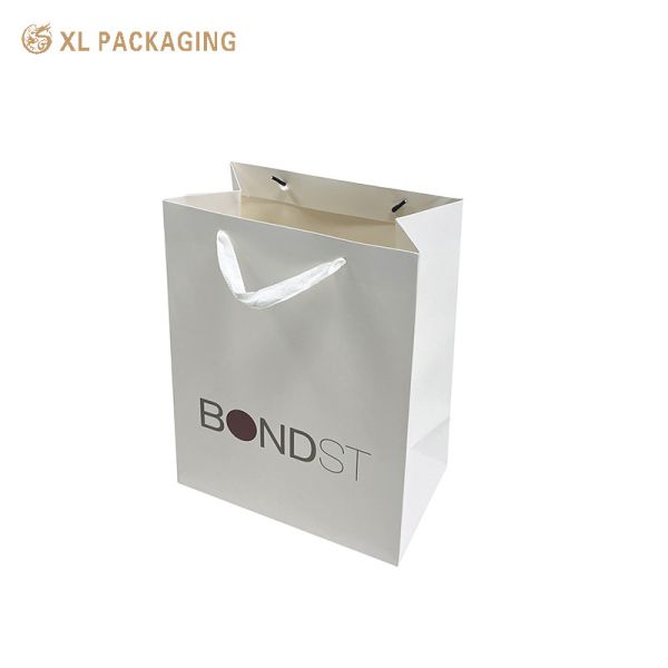 XL Packaging Custom Packaging Factory Professional Custom Paper Bag White Edge White One For Shopping Clothing Shoes Packing Shopping Bag With Logo