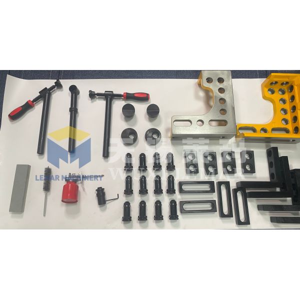 Complete set of welding table accessories including clamps, pins, and blocks